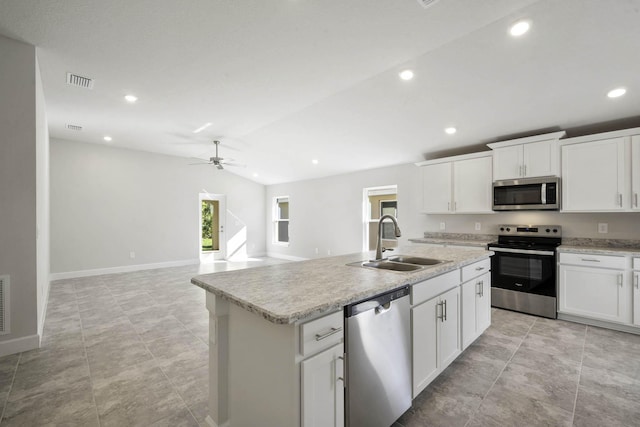 kitchen with white cabinets, a center island with sink, sink, ceiling fan, and stainless steel appliances