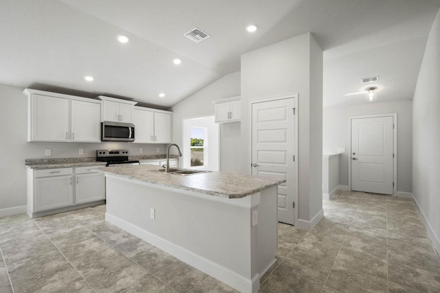 kitchen featuring sink, stainless steel appliances, an island with sink, lofted ceiling, and white cabinets