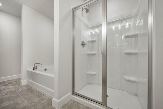 bathroom featuring tile patterned floors and shower with separate bathtub