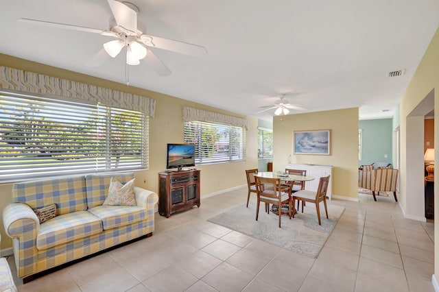 tiled dining room featuring ceiling fan