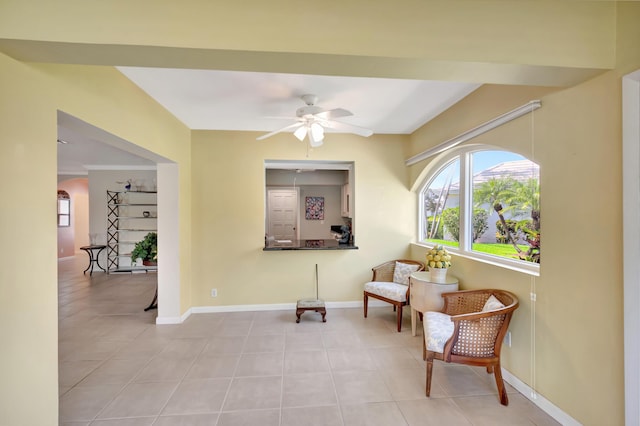 sitting room with light tile patterned floors and ceiling fan