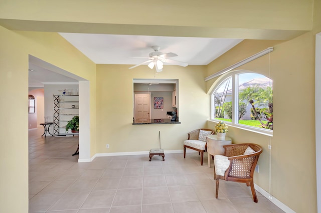 sitting room with light tile patterned flooring and ceiling fan