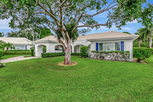 ranch-style home featuring a front lawn