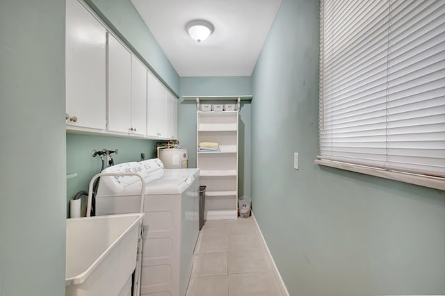 laundry room with cabinets, sink, light tile patterned floors, and independent washer and dryer