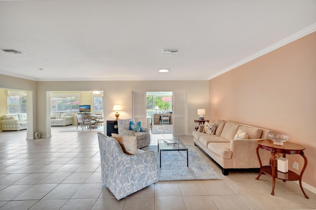 living room featuring crown molding and light tile patterned floors