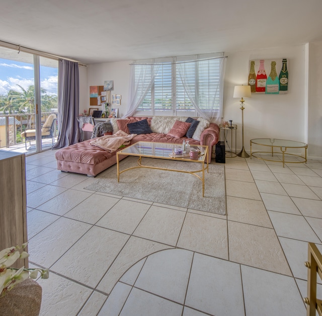 tiled living room featuring a wall of windows and a wealth of natural light