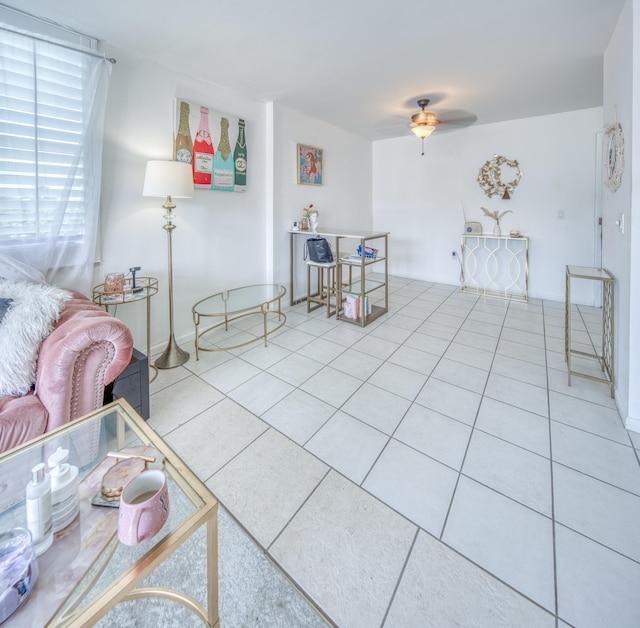 living room featuring ceiling fan and light tile patterned flooring