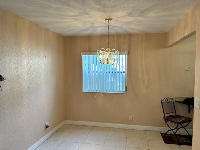 unfurnished dining area featuring a notable chandelier