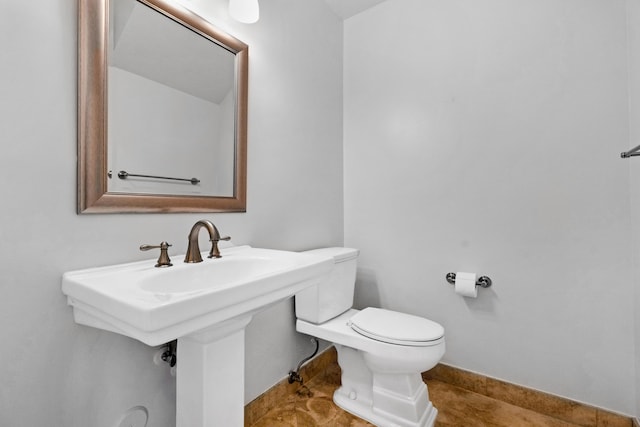 bathroom with toilet and tile patterned floors