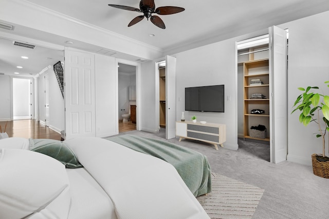 carpeted bedroom featuring crown molding and ceiling fan