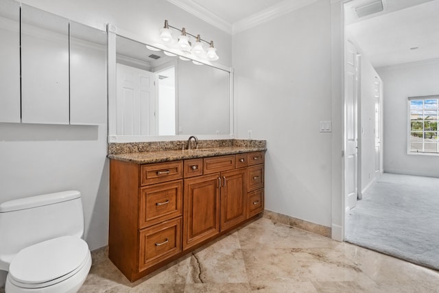 bathroom featuring toilet, vanity, and ornamental molding