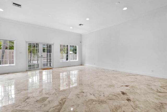 empty room featuring crown molding and french doors