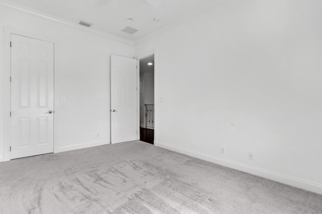 carpeted spare room featuring ornamental molding