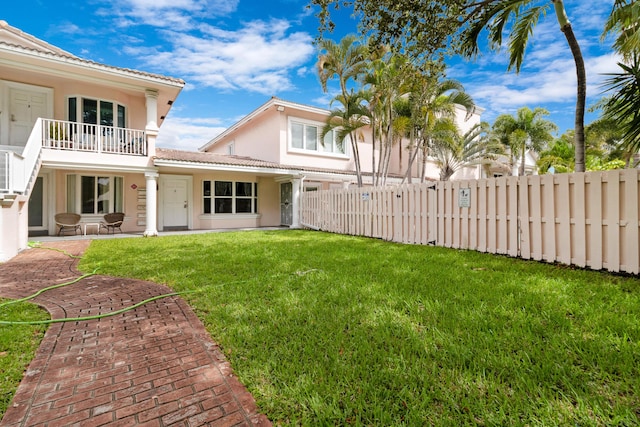 view of yard featuring a balcony and a patio area