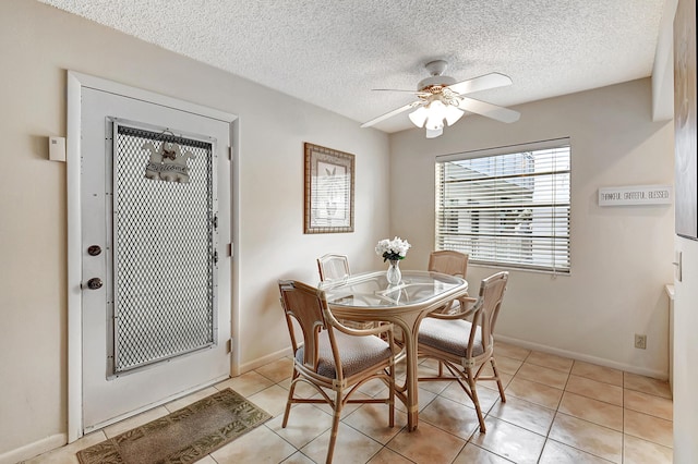 dining room featuring light tile patterned flooring, a textured ceiling, and ceiling fan