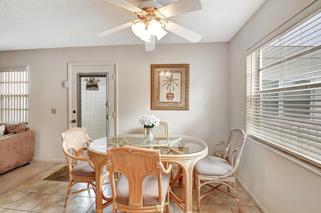 dining room with ceiling fan, light tile patterned floors, and a textured ceiling