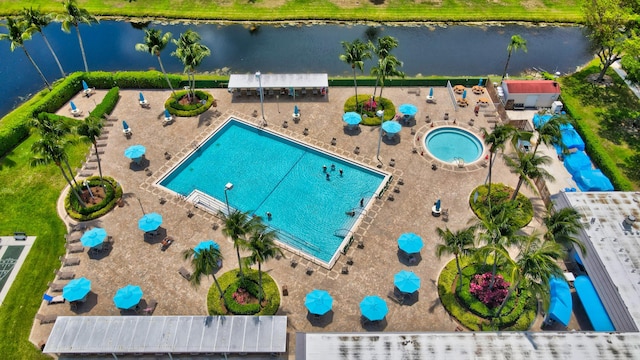 view of pool with a patio, a water view, and a community hot tub