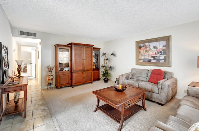 tiled living room with washer / dryer and a textured ceiling