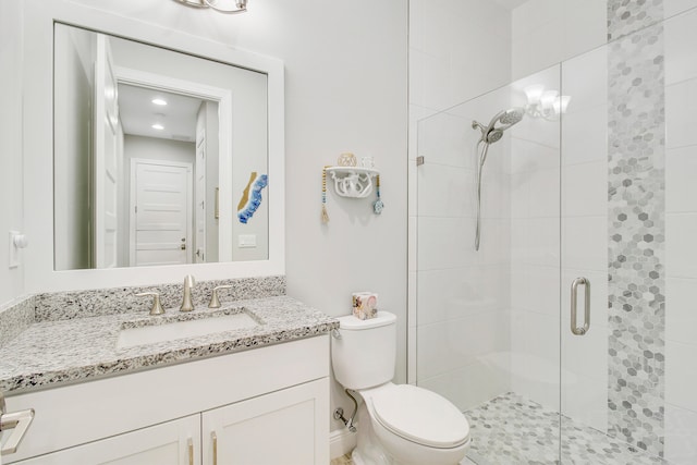 bathroom with vanity, toilet, and an enclosed shower