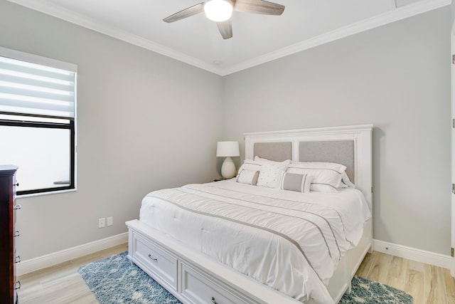 bedroom featuring light wood-type flooring, ornamental molding, and ceiling fan