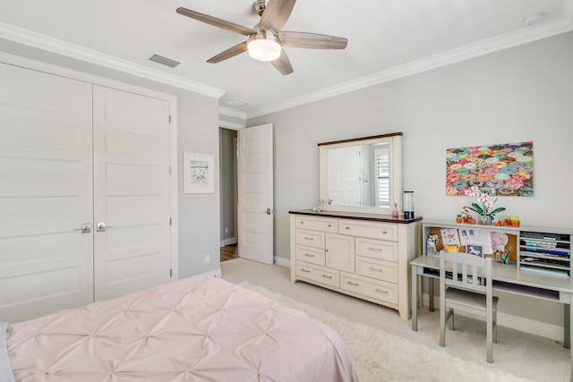 bedroom with ornamental molding, light colored carpet, ceiling fan, and a closet