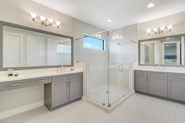 bathroom featuring a shower with door and vanity