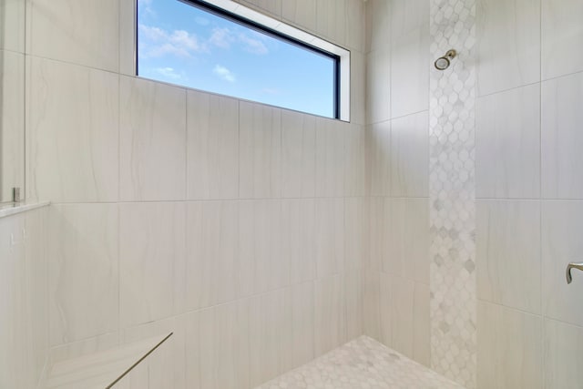 bathroom with a tile shower