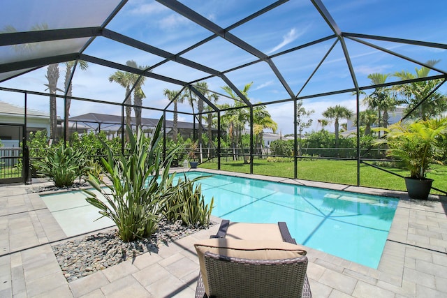 view of swimming pool featuring a lanai and a patio area