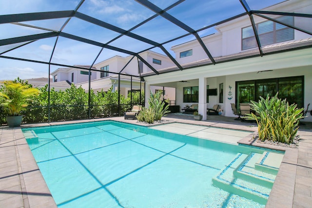 view of pool featuring ceiling fan, a lanai, and a patio