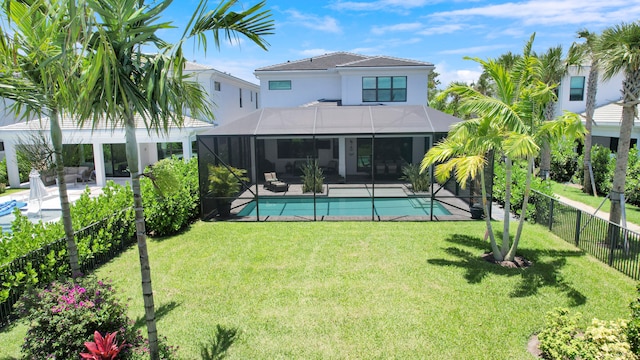 exterior space with glass enclosure, a lawn, and a patio