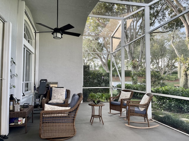 sunroom / solarium featuring outdoor lounge area, ceiling fan, and plenty of natural light