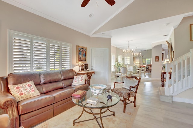 living room with crown molding, ceiling fan with notable chandelier, and high vaulted ceiling