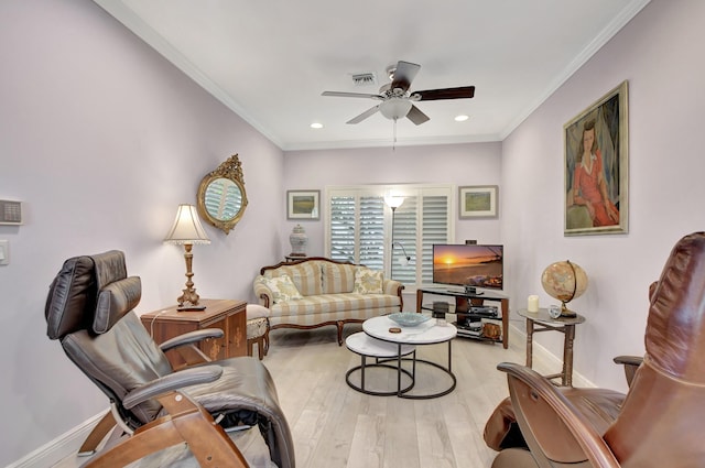 living room featuring ceiling fan, crown molding, and light hardwood / wood-style floors