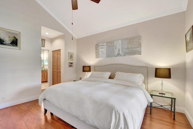 bedroom featuring ceiling fan, connected bathroom, lofted ceiling, and crown molding