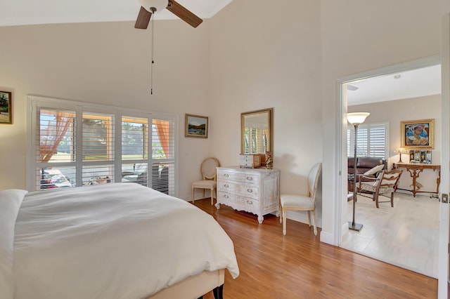 bedroom featuring ceiling fan, high vaulted ceiling, and wood-type flooring