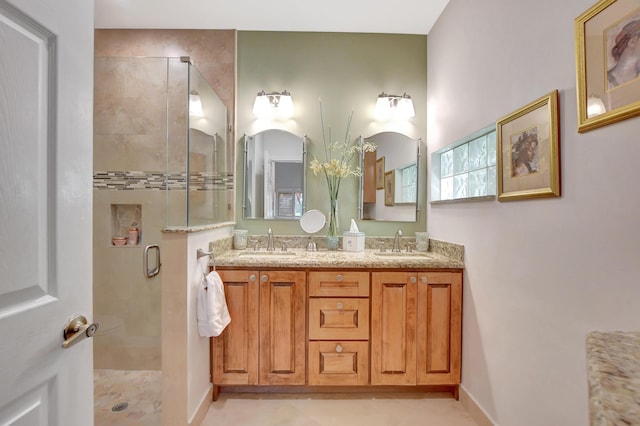 bathroom with a shower with door and vanity