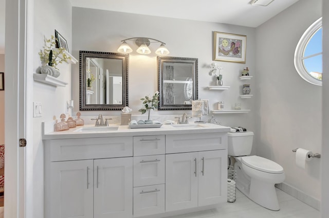 bathroom featuring toilet, tile patterned floors, and vanity