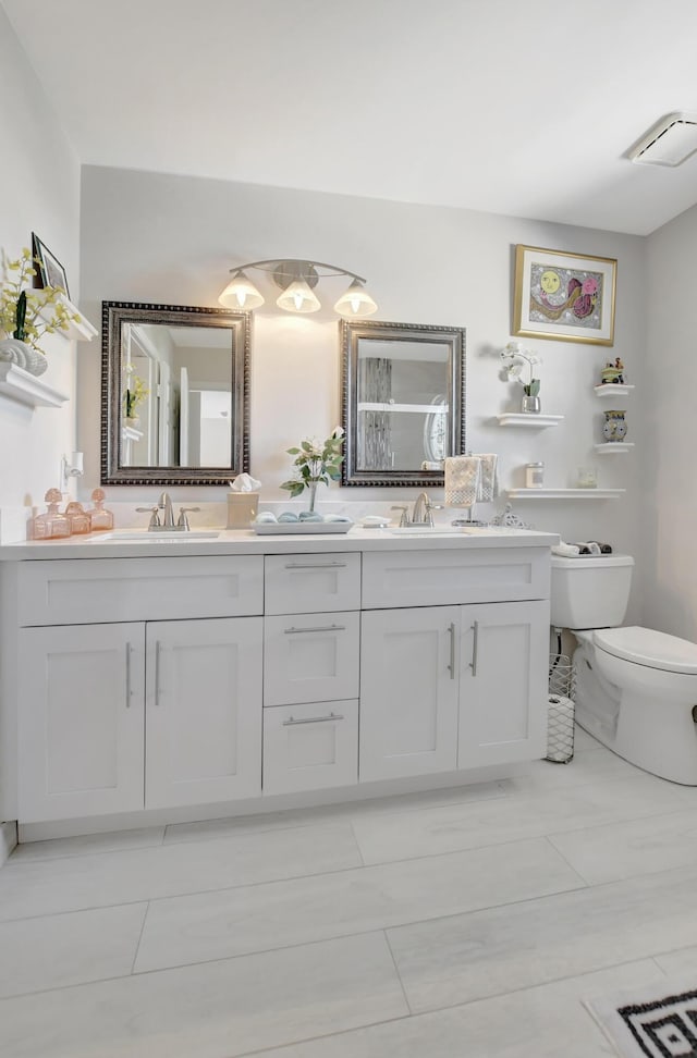 bathroom with vanity, toilet, and tile patterned flooring