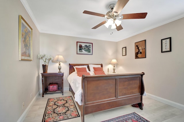 bedroom featuring ceiling fan, light hardwood / wood-style flooring, and crown molding