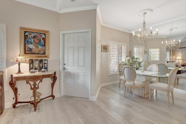 dining area featuring a notable chandelier, ornamental molding, and light hardwood / wood-style floors