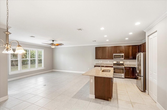 kitchen with decorative light fixtures, stainless steel appliances, ornamental molding, and sink