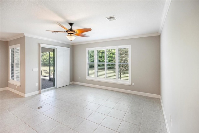 spare room featuring ceiling fan, light tile patterned flooring, a textured ceiling, and ornamental molding