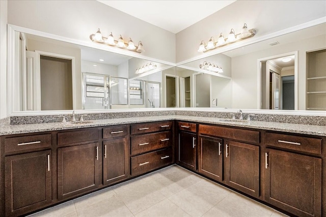 bathroom featuring tile patterned flooring, vanity, and an enclosed shower