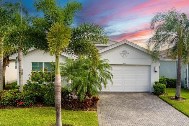 view of front of house with a yard and a garage