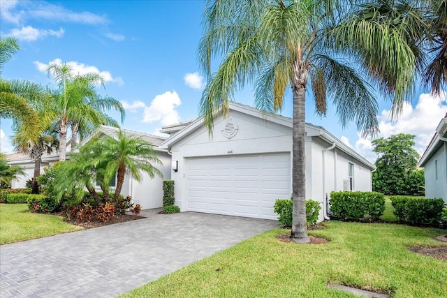 view of front of property with a front yard and a garage