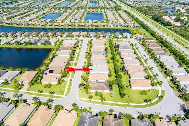birds eye view of property featuring a water view and a residential view