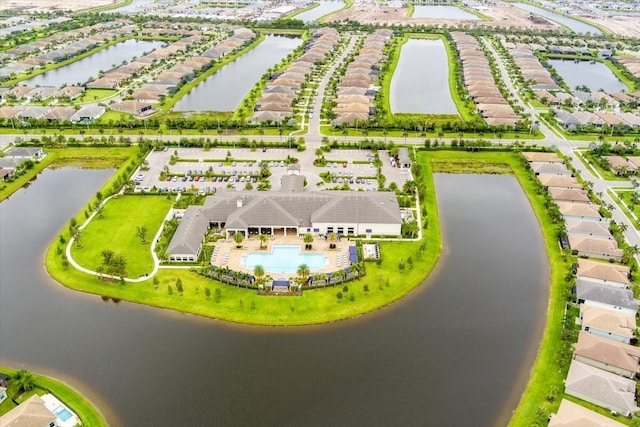 drone / aerial view with a water view and a residential view