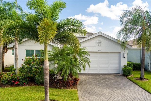 view of front of home featuring a front yard and a garage