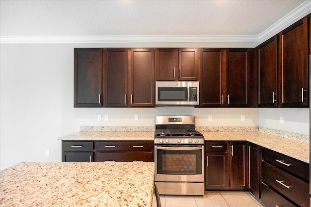 kitchen featuring light stone countertops, light tile patterned floors, ornamental molding, dark brown cabinetry, and stainless steel appliances