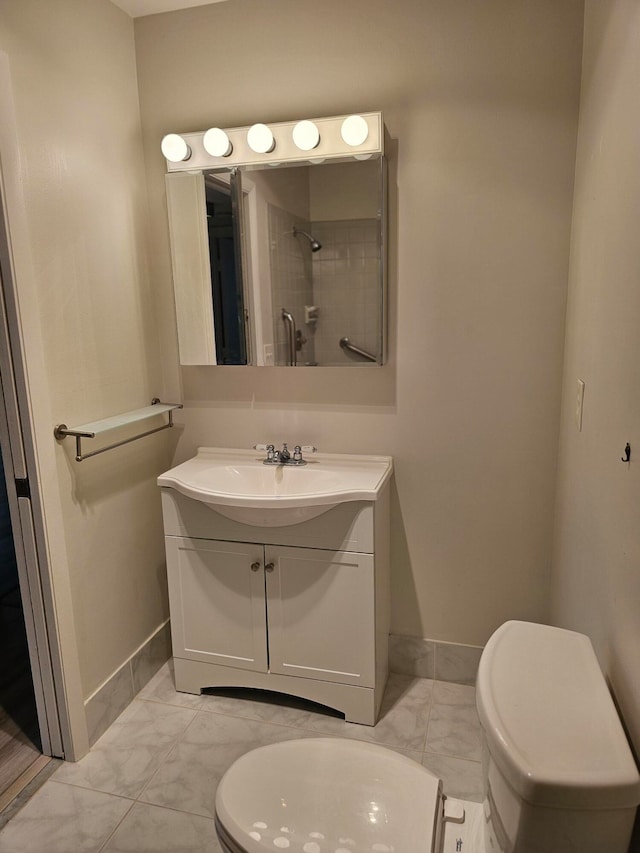 bathroom with vanity, tile patterned floors, and toilet